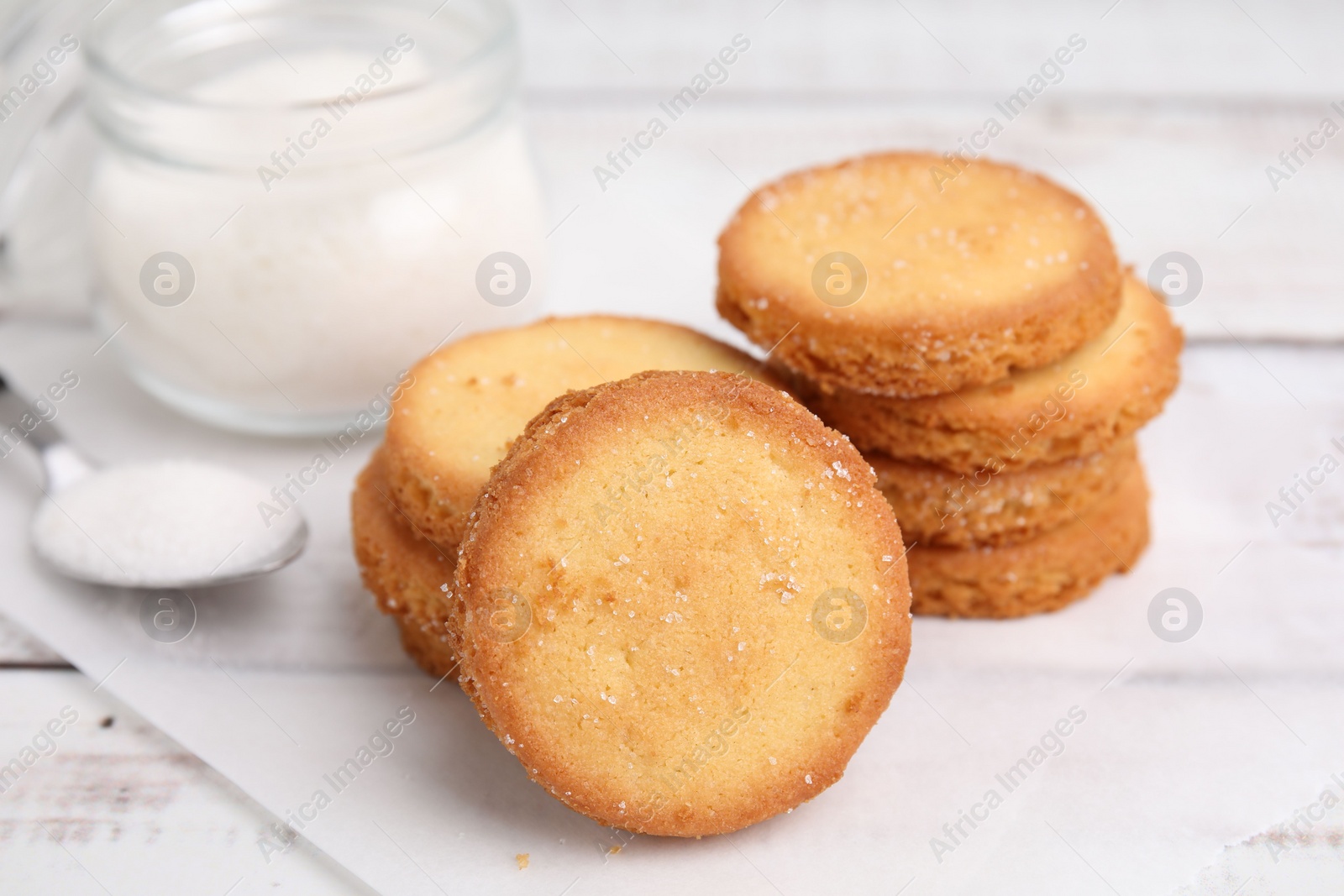 Photo of Tasty sweet sugar cookies on white wooden table, closeup