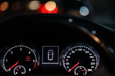 Closeup view of dashboard with warning icon check airbag system in car