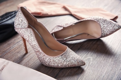Photo of Beautiful high heeled shoes on floor