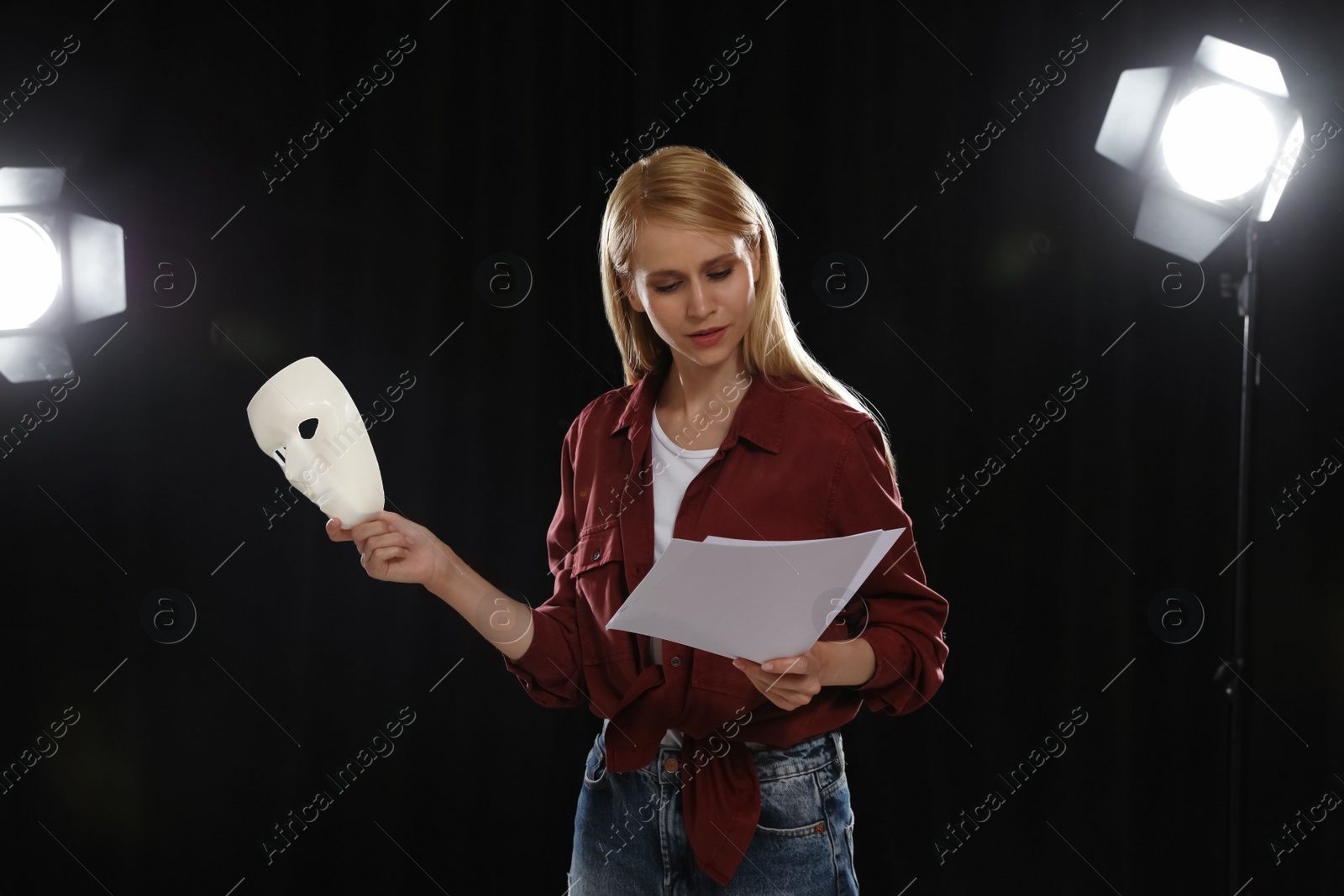 Photo of Professional actress reading her script during rehearsal in theatre