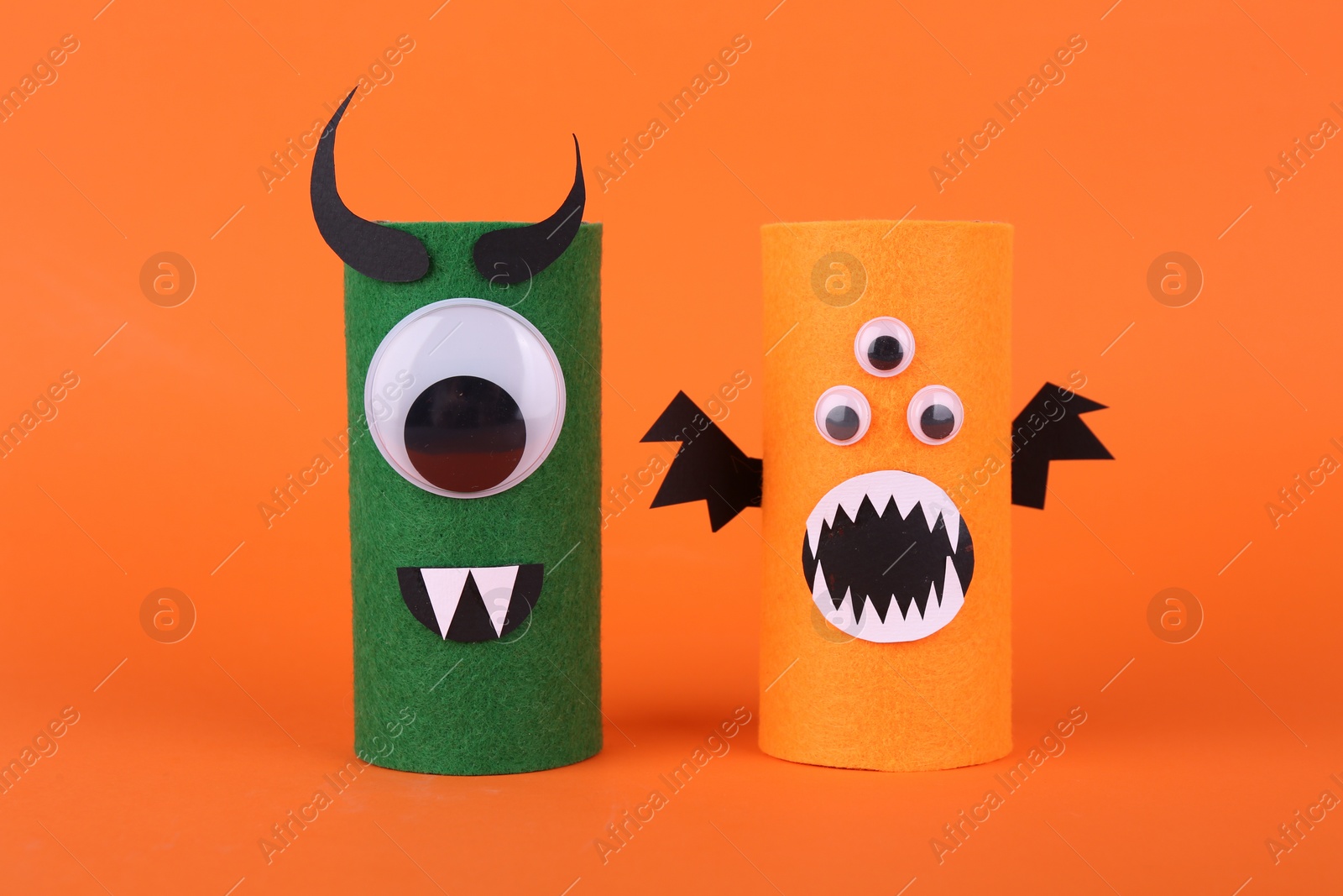 Photo of Spooky monsters on orange background. Handmade Halloween decoration