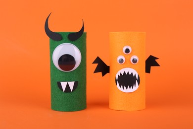 Spooky monsters on orange background. Handmade Halloween decoration