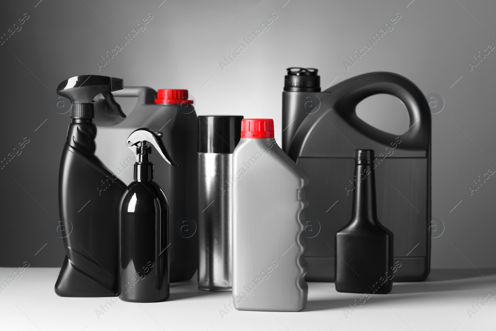 Photo of Different bottles of car products on white table