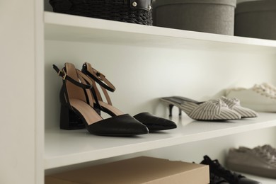 Photo of Storage rack with stylish women's shoes and accessories