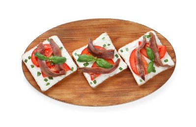 Delicious sandwiches with cream cheese, anchovies, tomatoes and basil on white background, top view