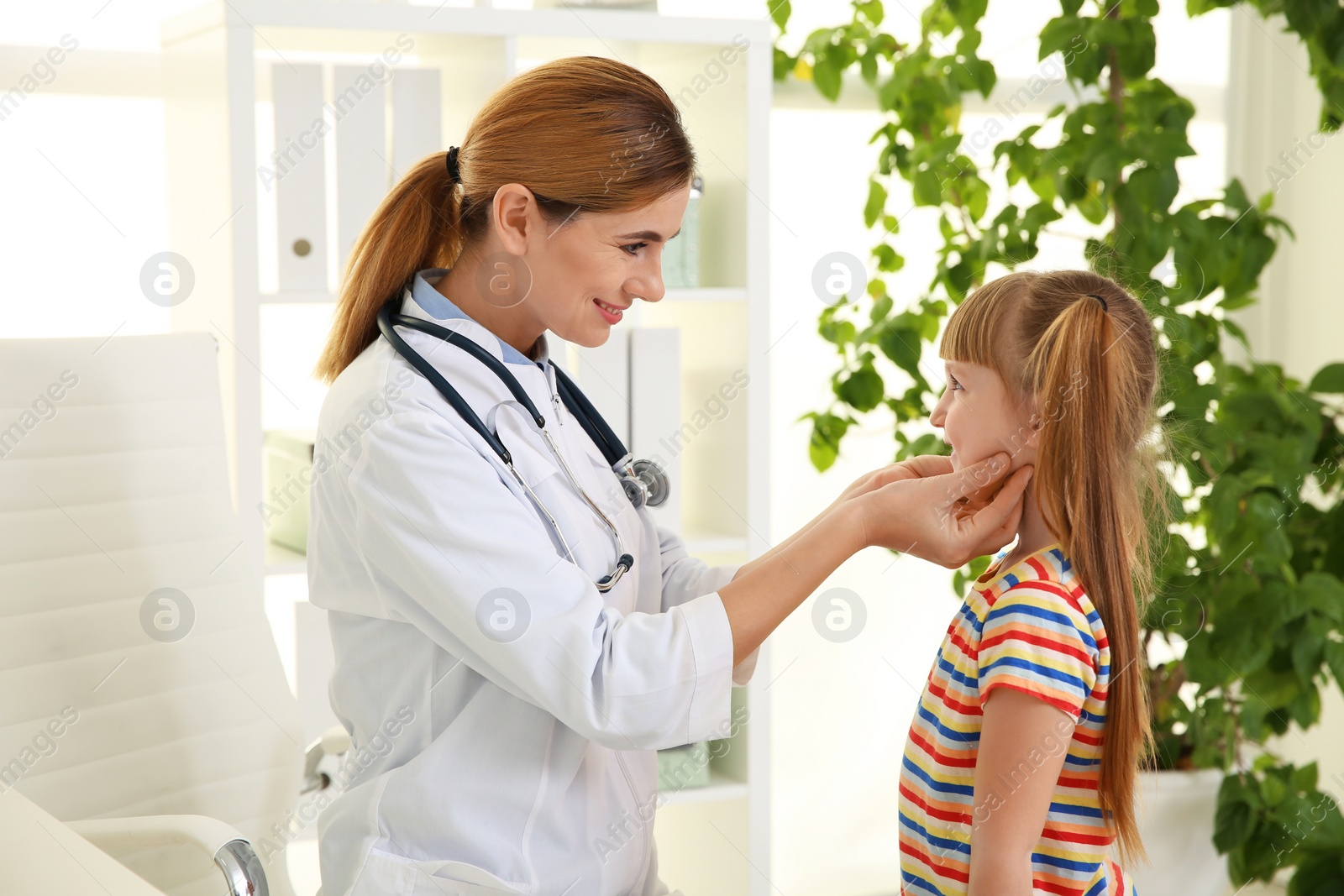 Photo of Doctor working with little patient in hospital