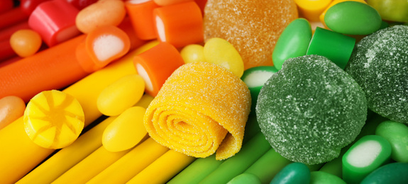 Delicious colorful chewing candies as background. Banner design 