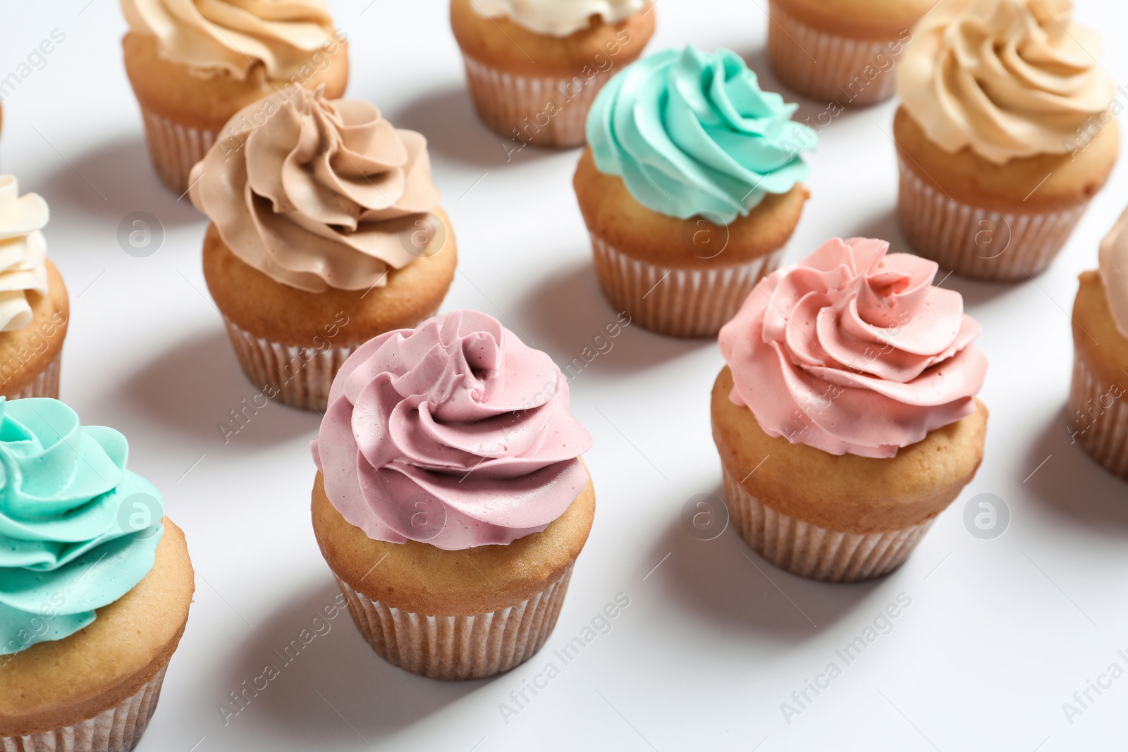 Photo of Delicious birthday cupcakes on white background, closeup