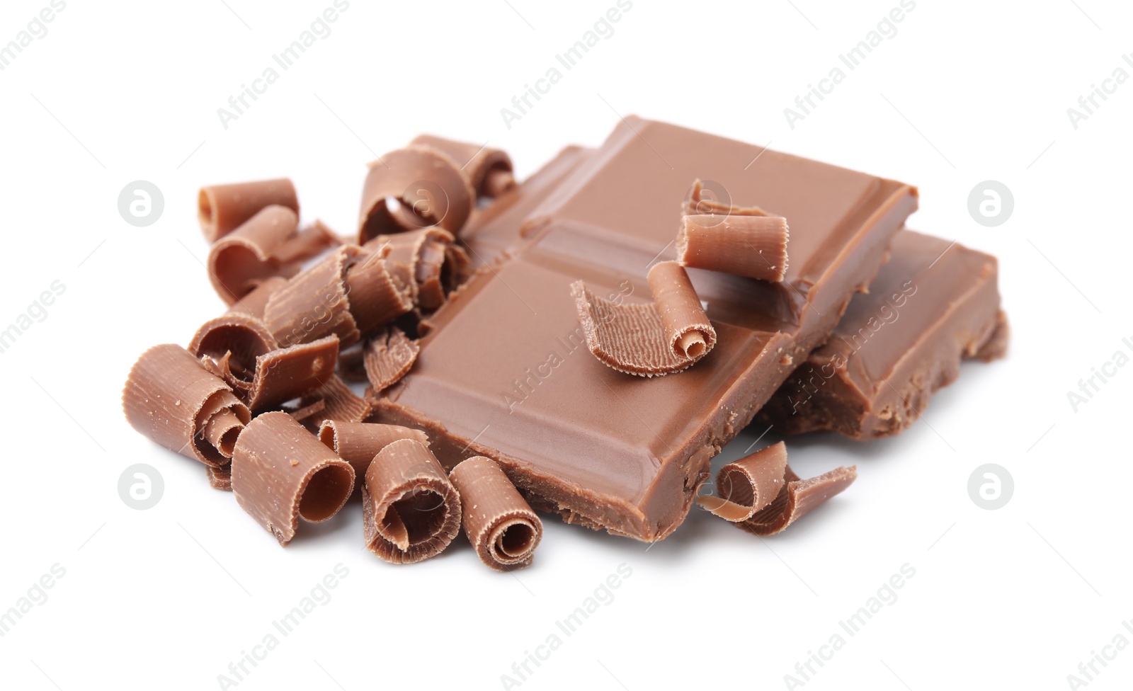 Photo of Pieces of tasty chocolate bar and shavings isolated on white