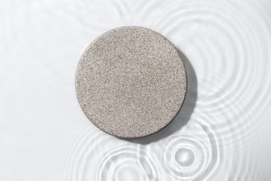 Photo of Presentation for product. Stone podium in water on white background, top view