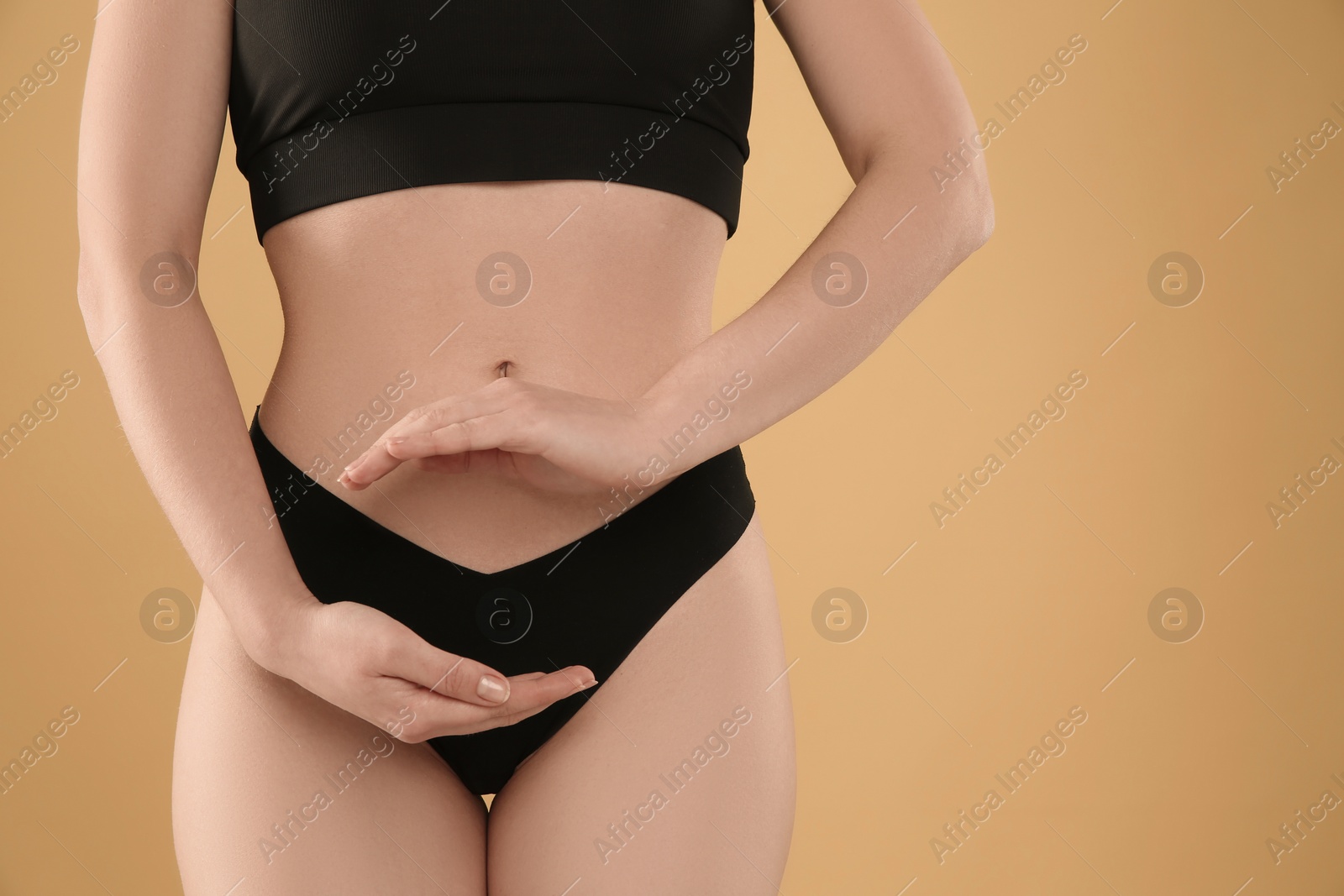 Photo of Gynecology. Woman in underwear on yellow background, closeup. Space for text