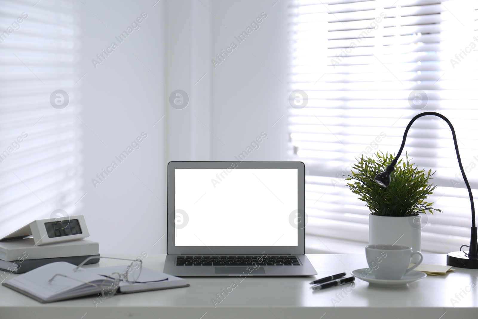 Photo of Modern laptop on office table. Stylish workplace