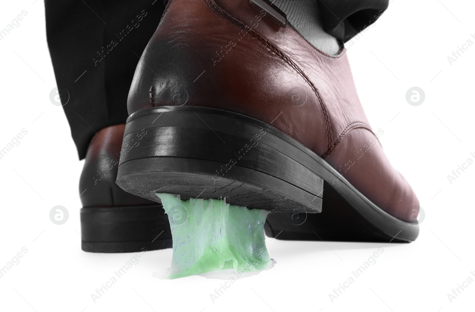 Photo of Man stepping into chewing gum on white background, closeup