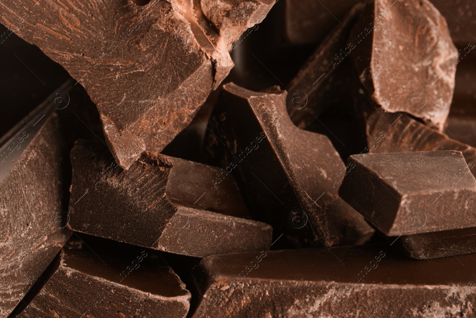 Photo of Pieces of dark chocolate as background, closeup