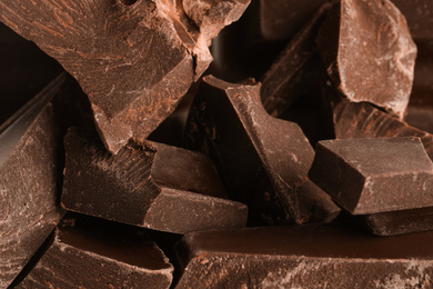 Pieces of dark chocolate as background, closeup