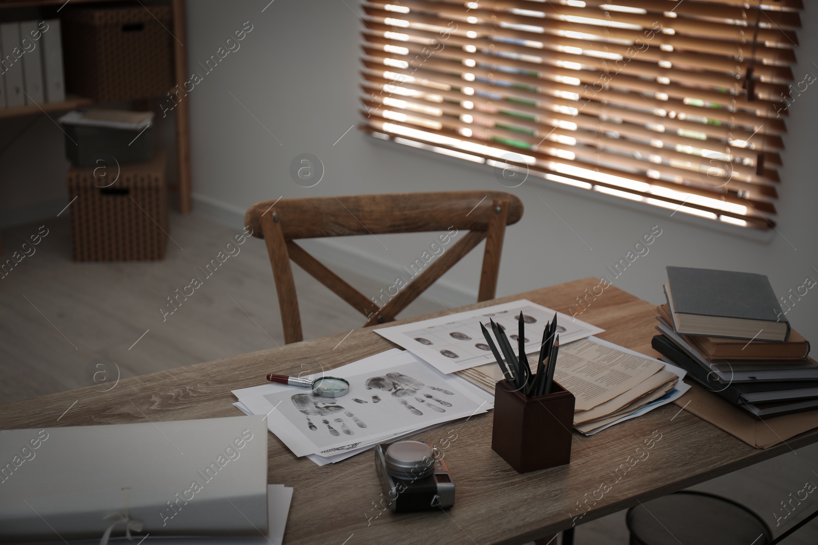 Photo of Fingerprints and papers on desk in office. Detective's workplace