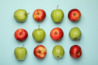 Photo of Fresh colorful apples on light blue background, flat lay