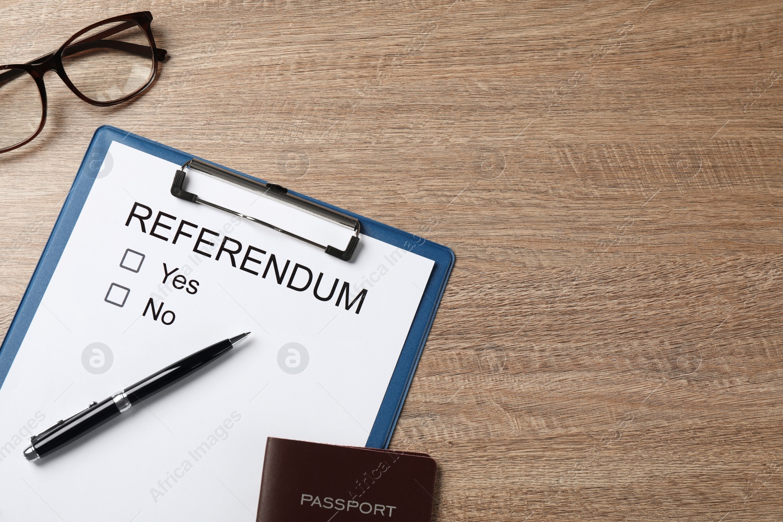 Photo of Flat lay composition with referendum ballot on wooden table. Space for text