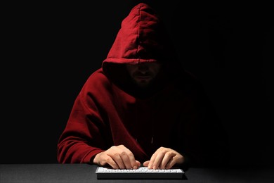 Hacker working with keyboard in dark room. Cyber attack