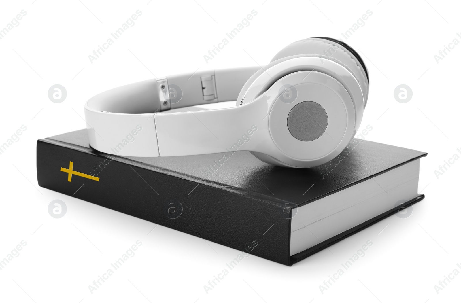 Photo of Bible and headphones on white background. Religious audiobook