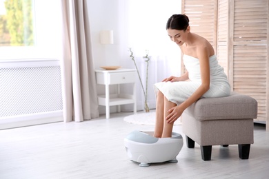 Photo of Woman with beautiful legs using foot bath at home, space for text. Spa treatment