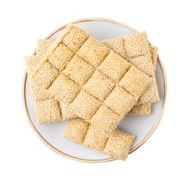 Plate with tasty sesame kozinaki bars on white background, top view