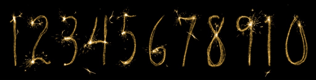 Set with numbers silhouettes made of sparkler on black background. Banner design 