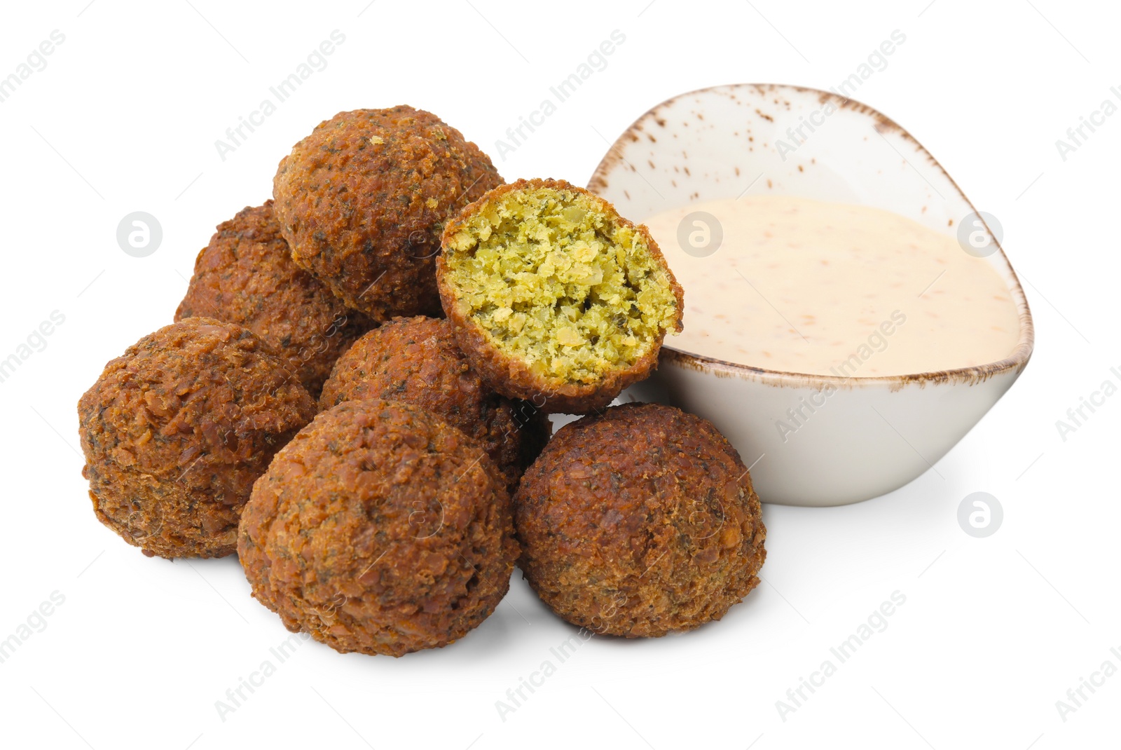 Photo of Delicious falafel balls and sauce isolated on white