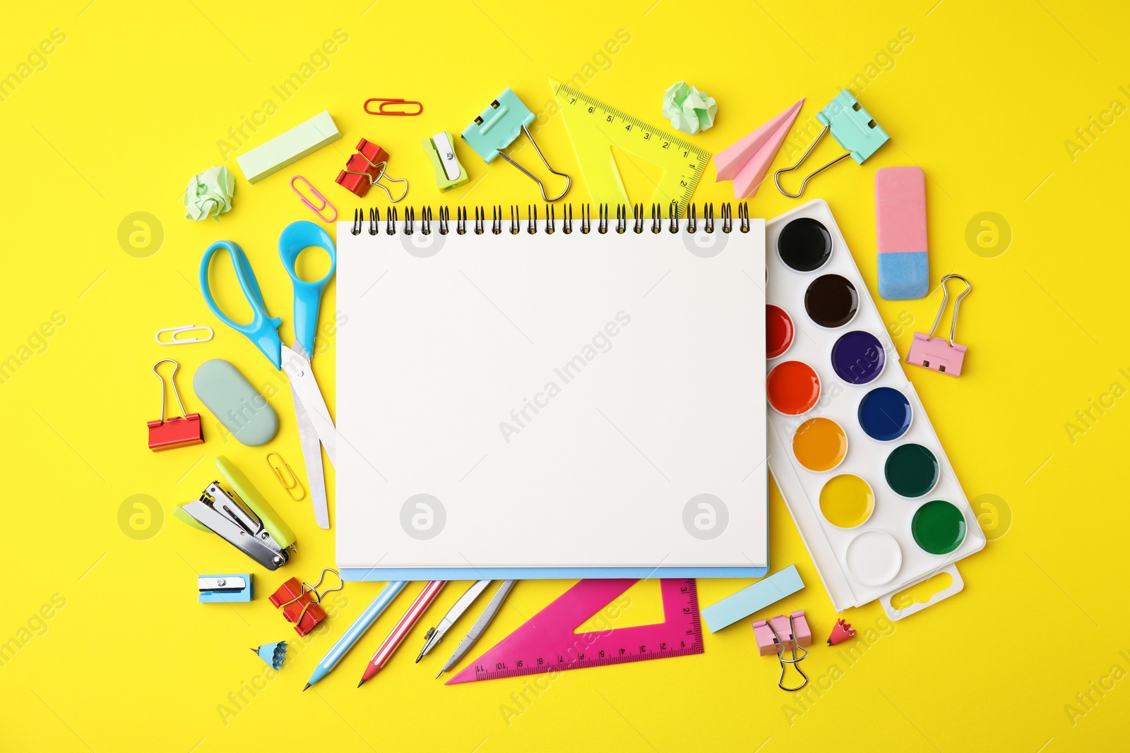 Photo of Flat lay composition with different school stationery on yellow background, space for text. Back to school