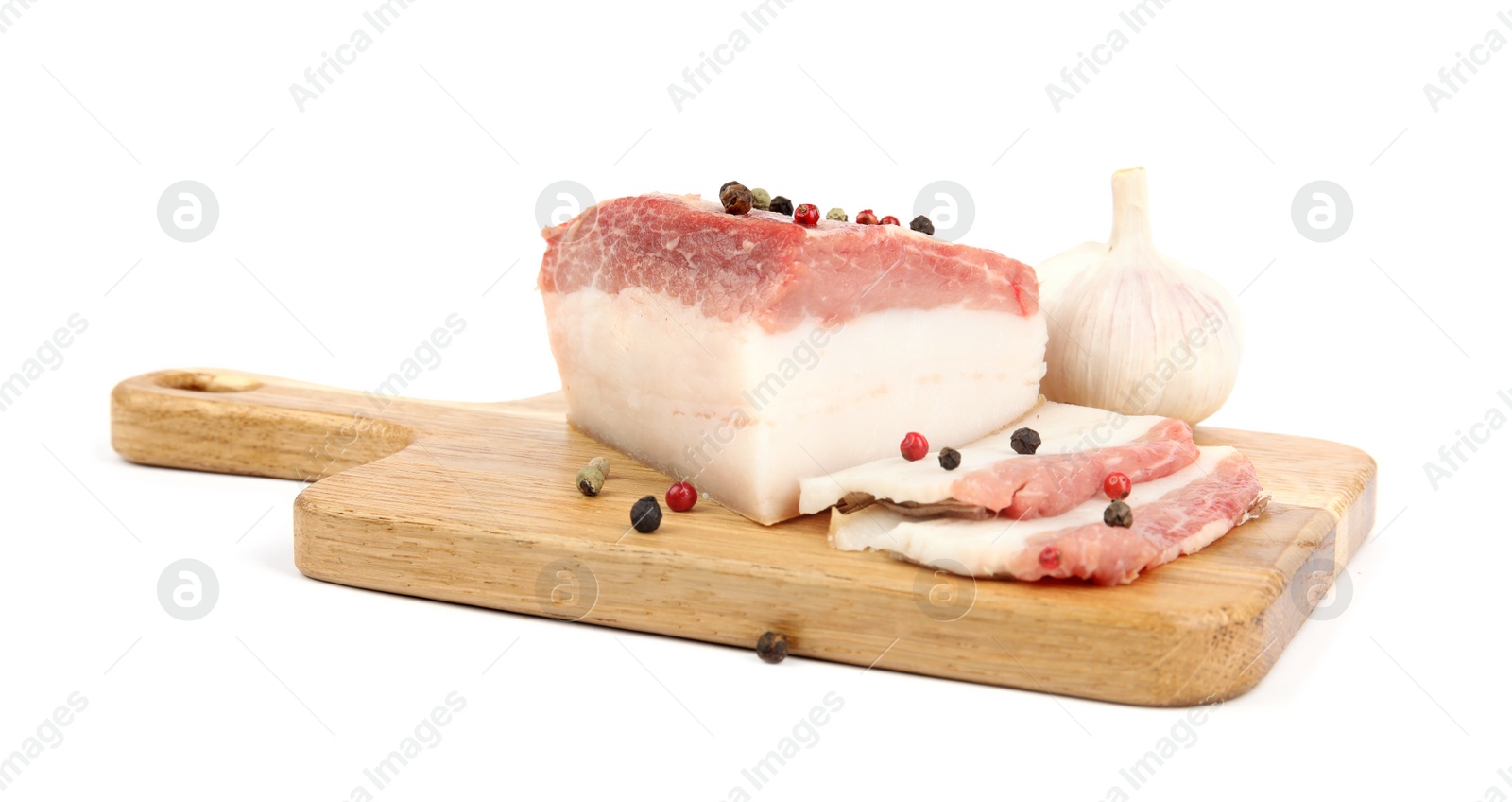 Photo of Board with cut pork fatback, pepper and garlic isolated on white