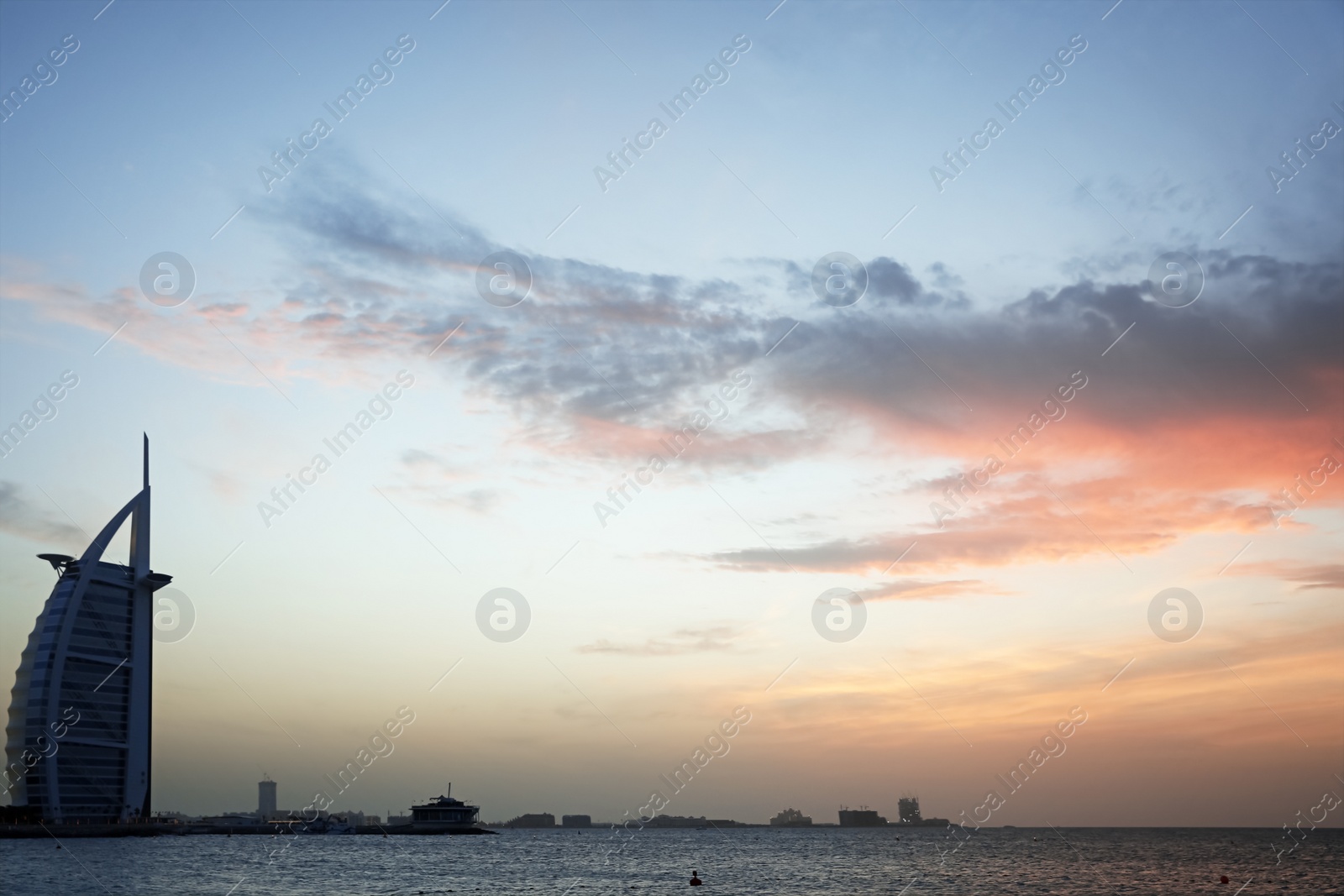 Photo of DUBAI, UNITED ARAB EMIRATES - NOVEMBER 03, 2018: Beautiful view of famous Burj Al Arab and amazing sunset sky