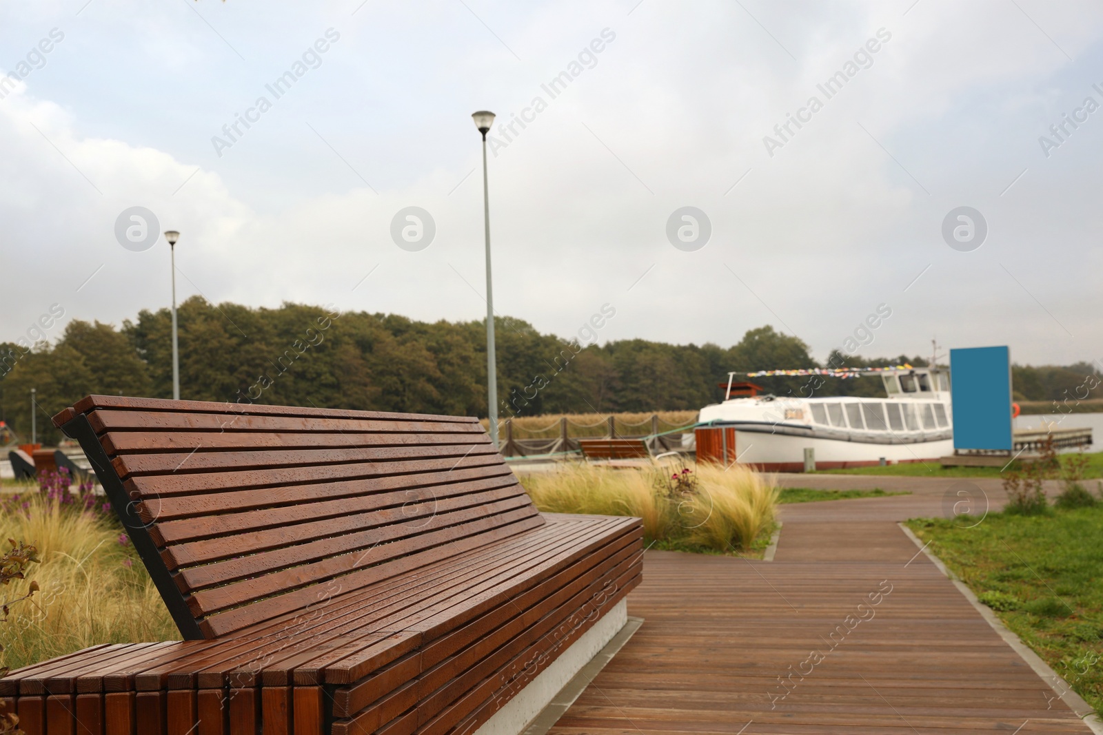 Photo of Recreation area with big wooden bench for rent outdoors. Real estate
