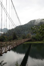 Photo of Beautiful view on rusty metal bridge over river in mountains