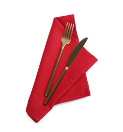 Photo of Red napkin with golden fork and knife on white background, top view