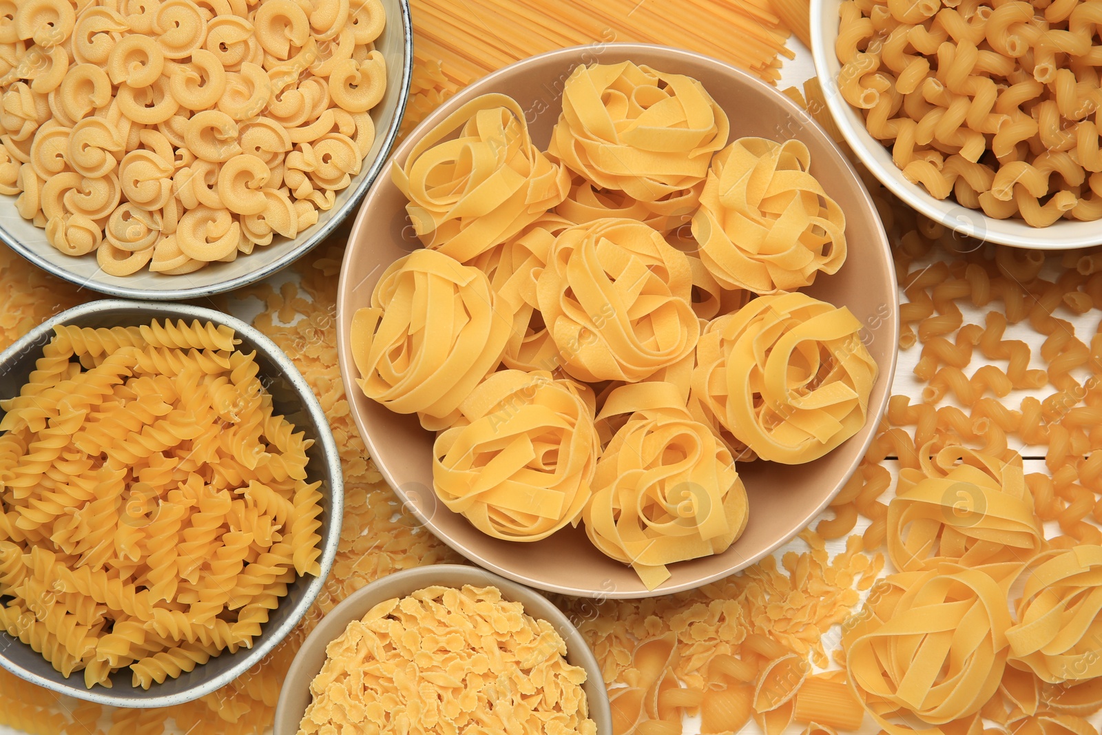 Photo of Different types of pasta on table, flat lay