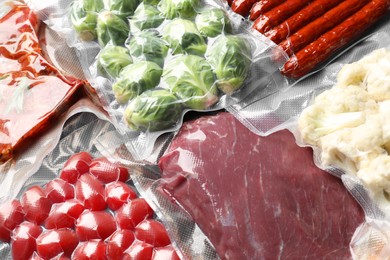 Photo of Many different food in vacuum packings as background, closeup