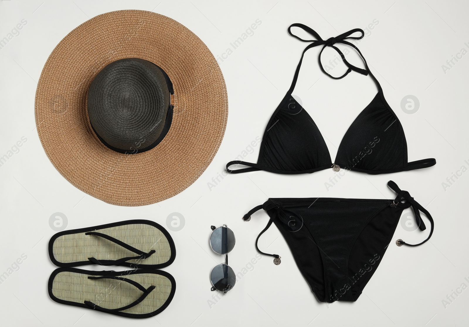 Photo of Flat lay composition with stylish beach accessories on light background