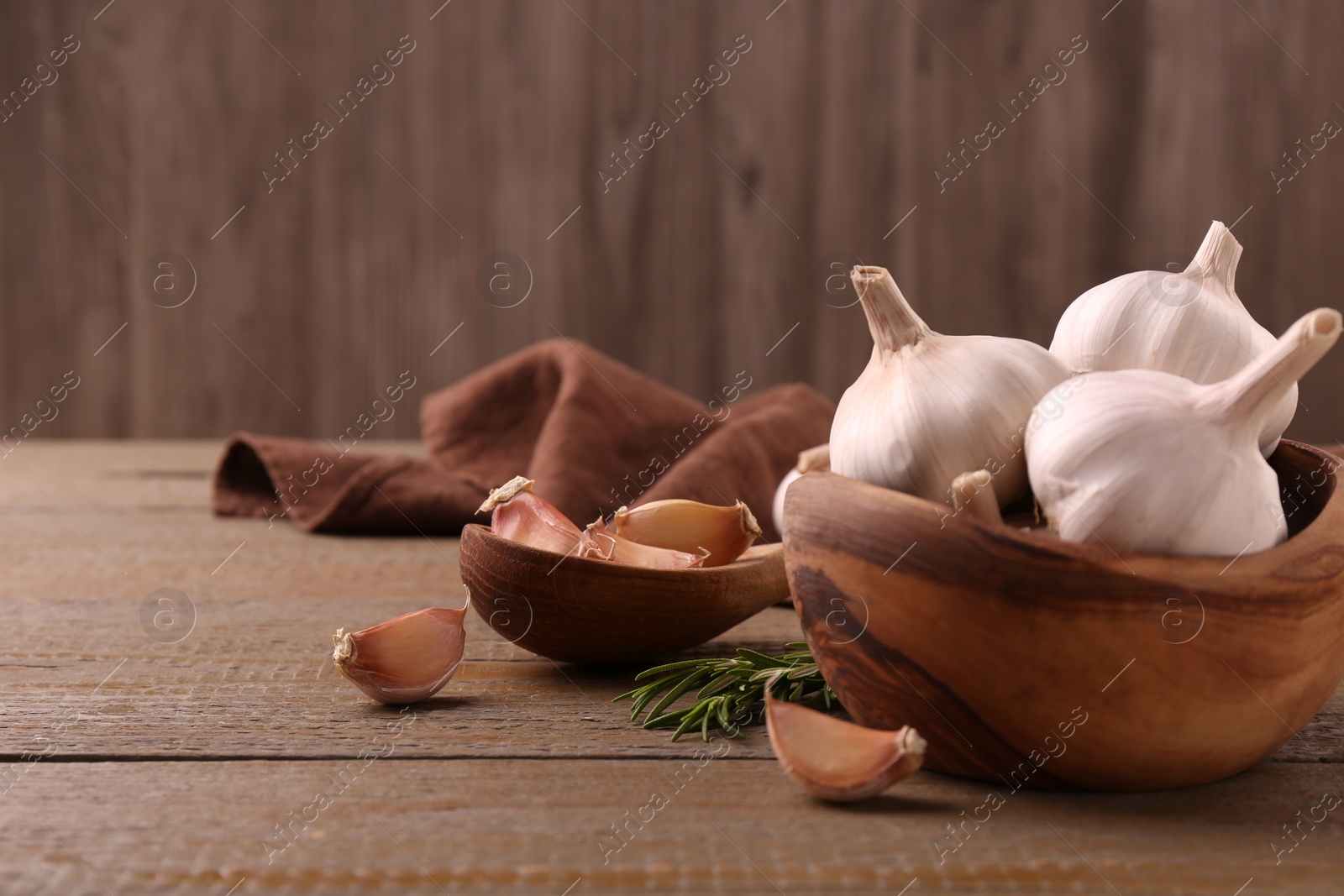 Photo of Fresh garlic on wooden table, closeup. Space for text