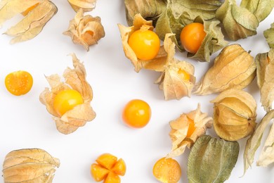 Photo of Ripe physalis fruits with dry husk on white background, top view