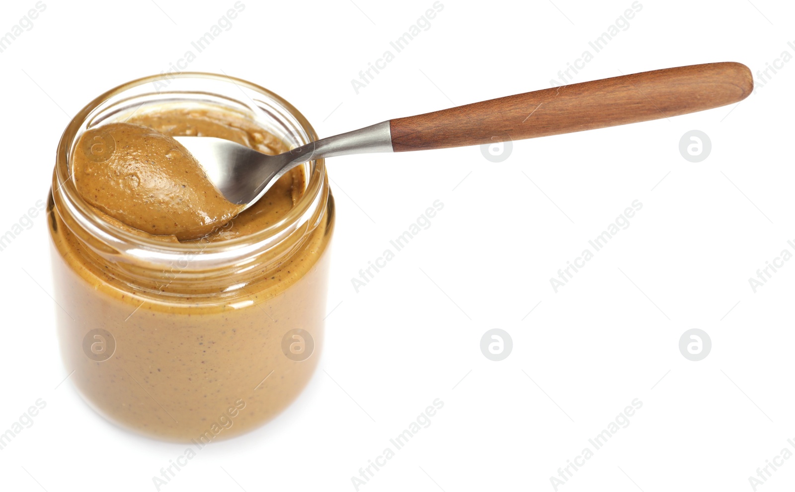 Photo of Tasty nut paste in jar and spoon isolated on white