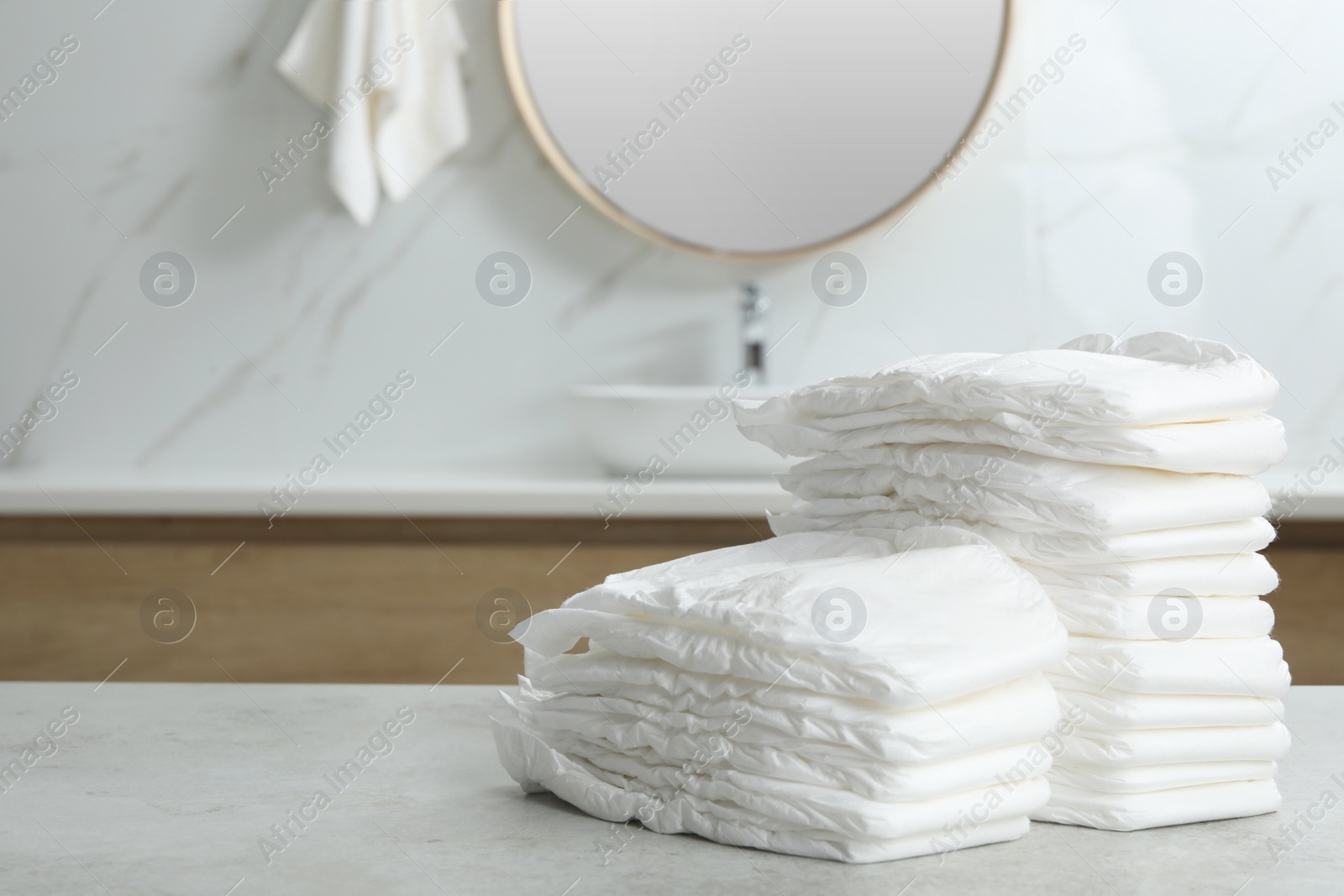 Photo of Stacks of baby diapers on counter in bathroom