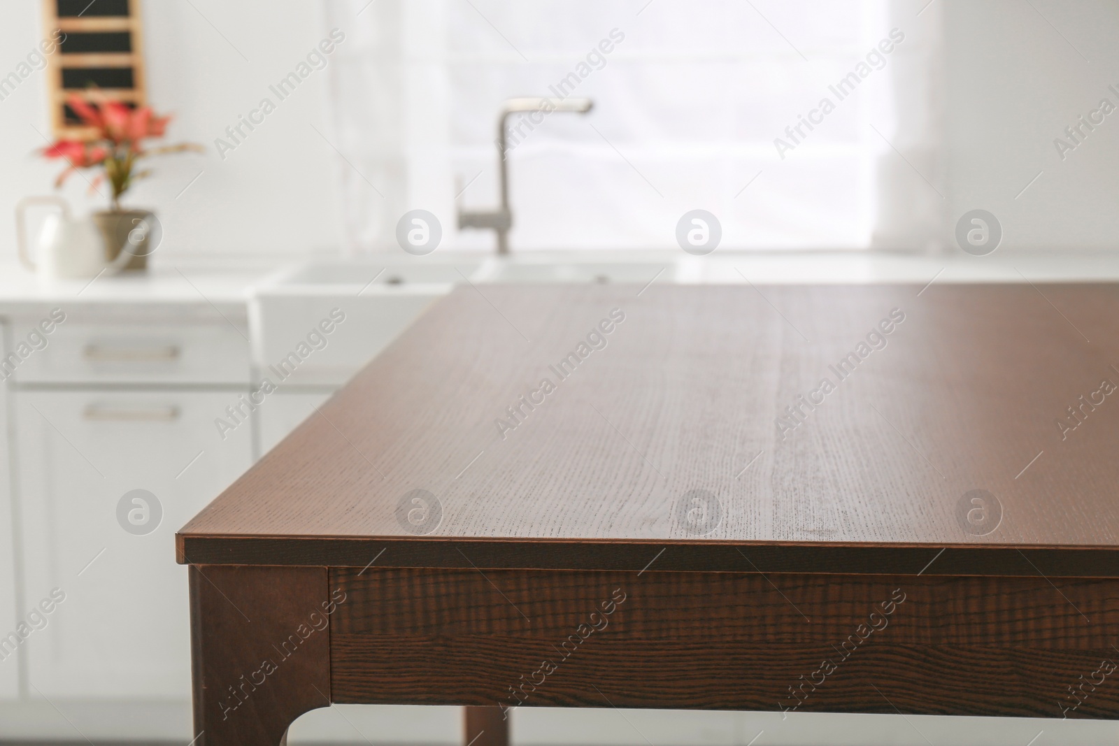 Photo of Stylish wooden table in kitchen. Interior design