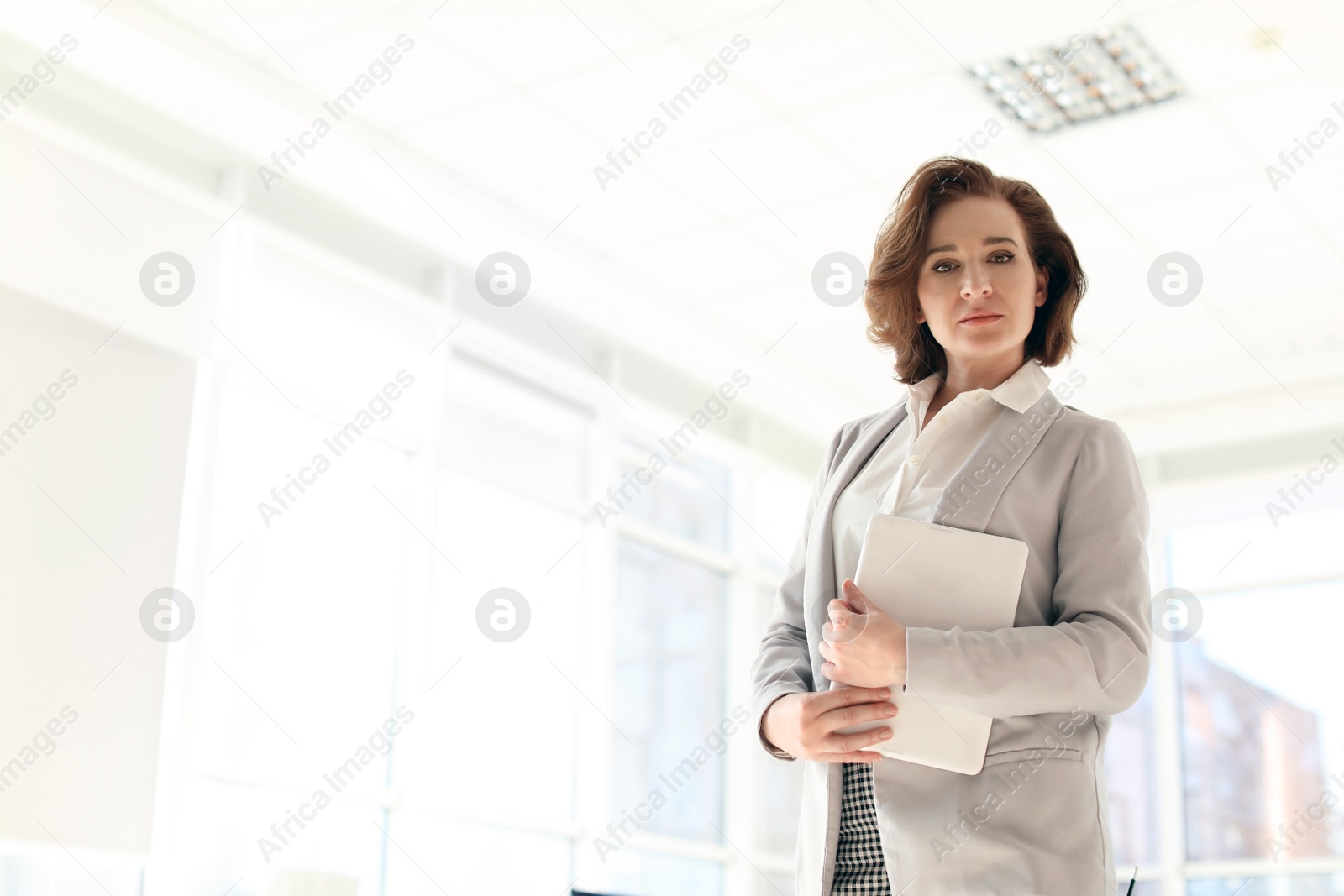 Photo of Female lawyer with tablet in light office