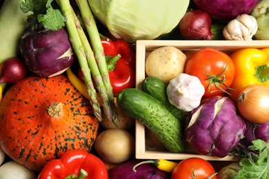 Many fresh ripe vegetables as background. Organic food