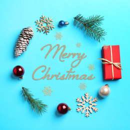 Image of Flat lay composition with text MERRY CHRISTMAS and festive decor on light blue background