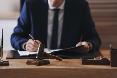 Photo of Male lawyer working at table in office, closeup