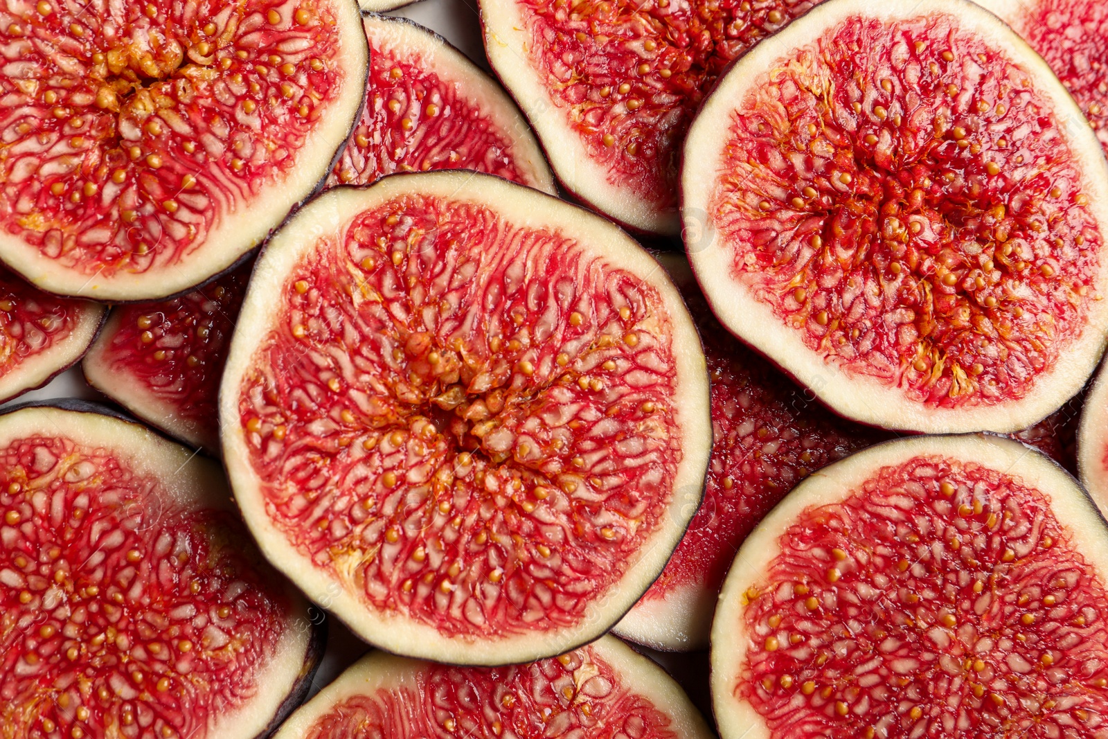 Photo of Pieces of fresh ripe figs on table, top view