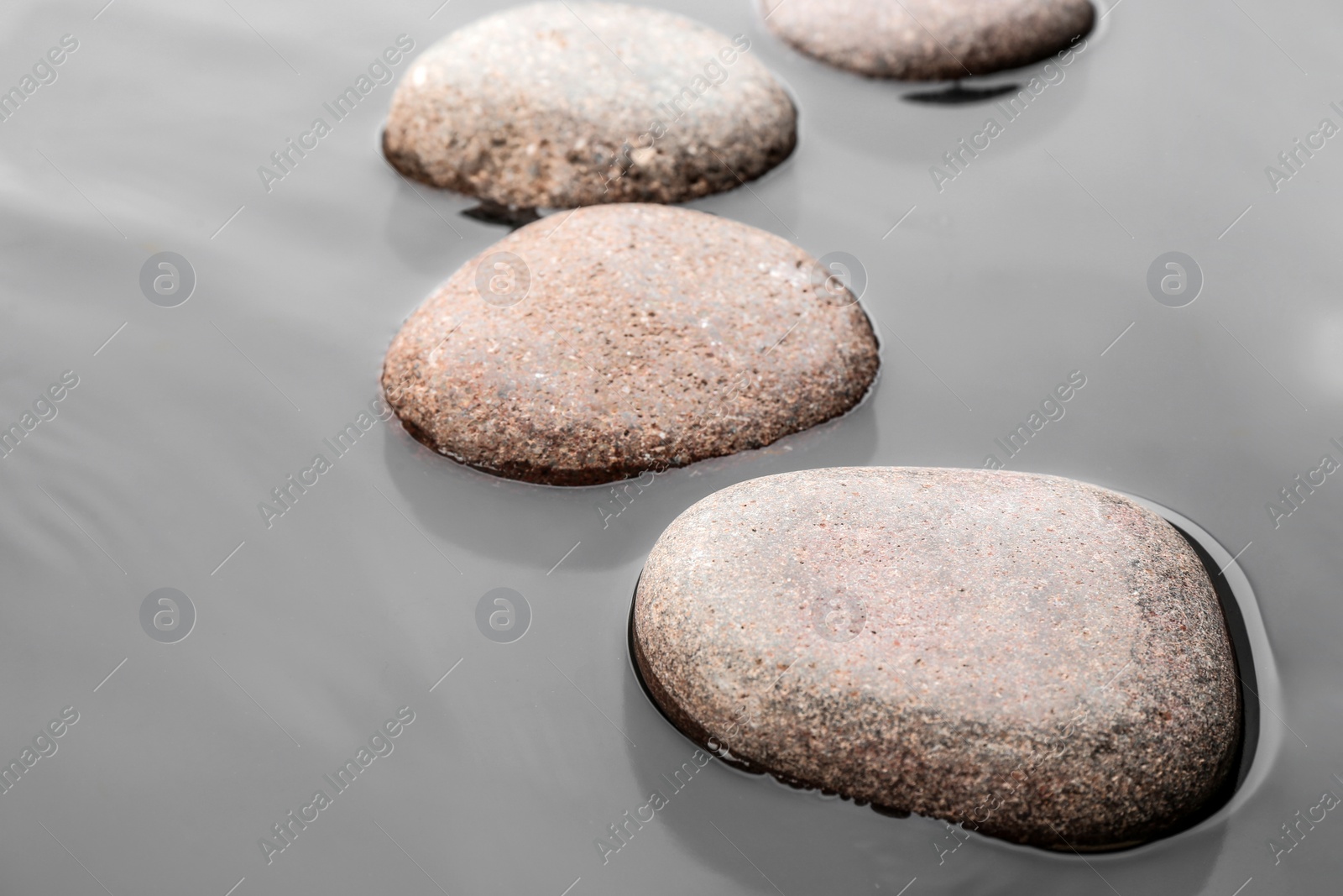 Photo of Wet stones in water, closeup. Zen lifestyle