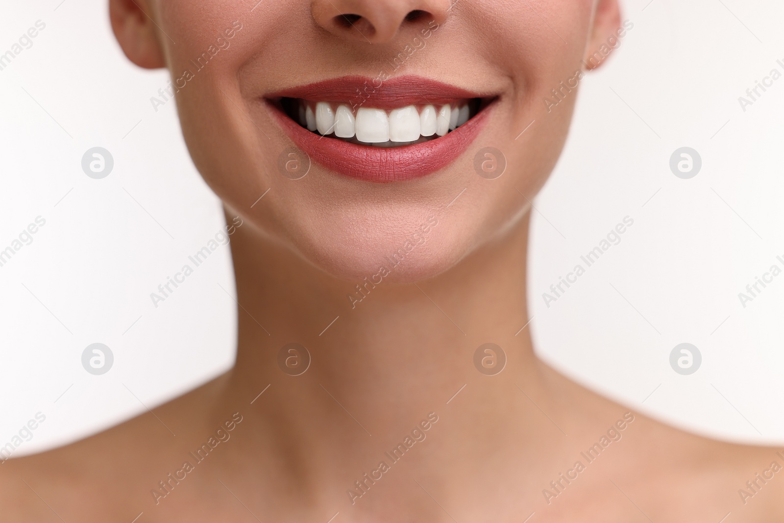 Photo of Woman with beautiful lips smiling on white background, closeup