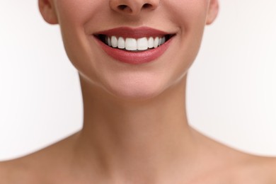 Photo of Woman with beautiful lips smiling on white background, closeup